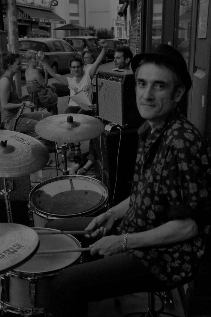 Portrait of Alain Hobé playing drums